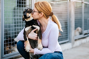 Woman kissing adopted dog