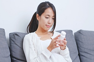 pet owner reading dog medicine label