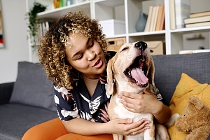 pet sitting hugging yawning dog