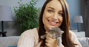 Cat sitter holding cat during Manassas, VA cat sitting services