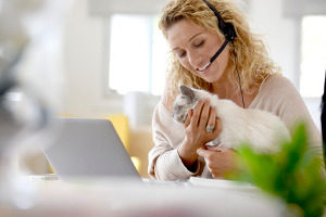 woman holding her cat and talking to a Northern VA cat sitting service reference