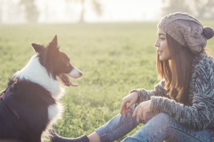 a dog with his new owner who read about things you should know before adopting a pet