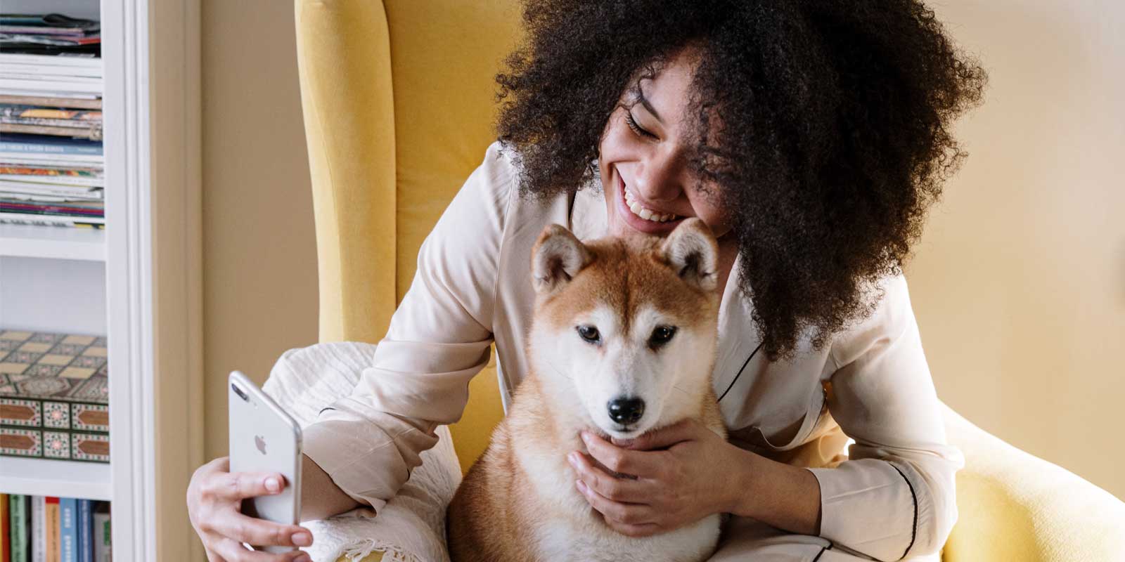 Woman preventing pet separation anxiety in dog