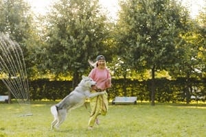 Woman Playing with Dog in Park
