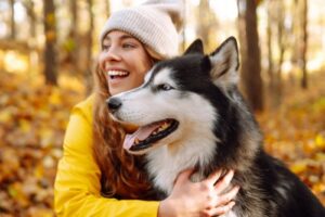 Dog and female owner enjoying a fall walk outdoors
